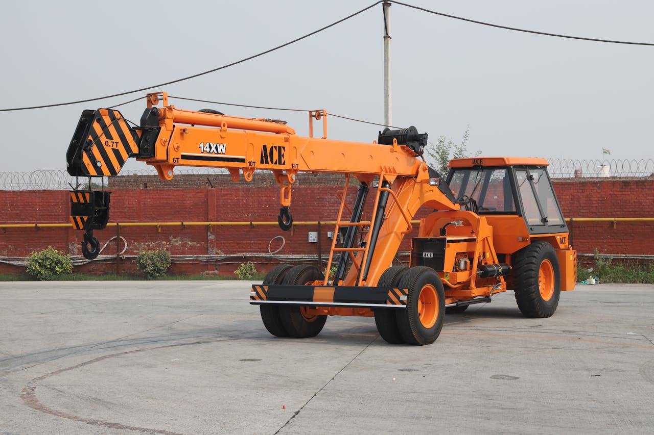 why-choose-us Orange ACE 14XW mobile crane in an industrial outdoor setting in India.