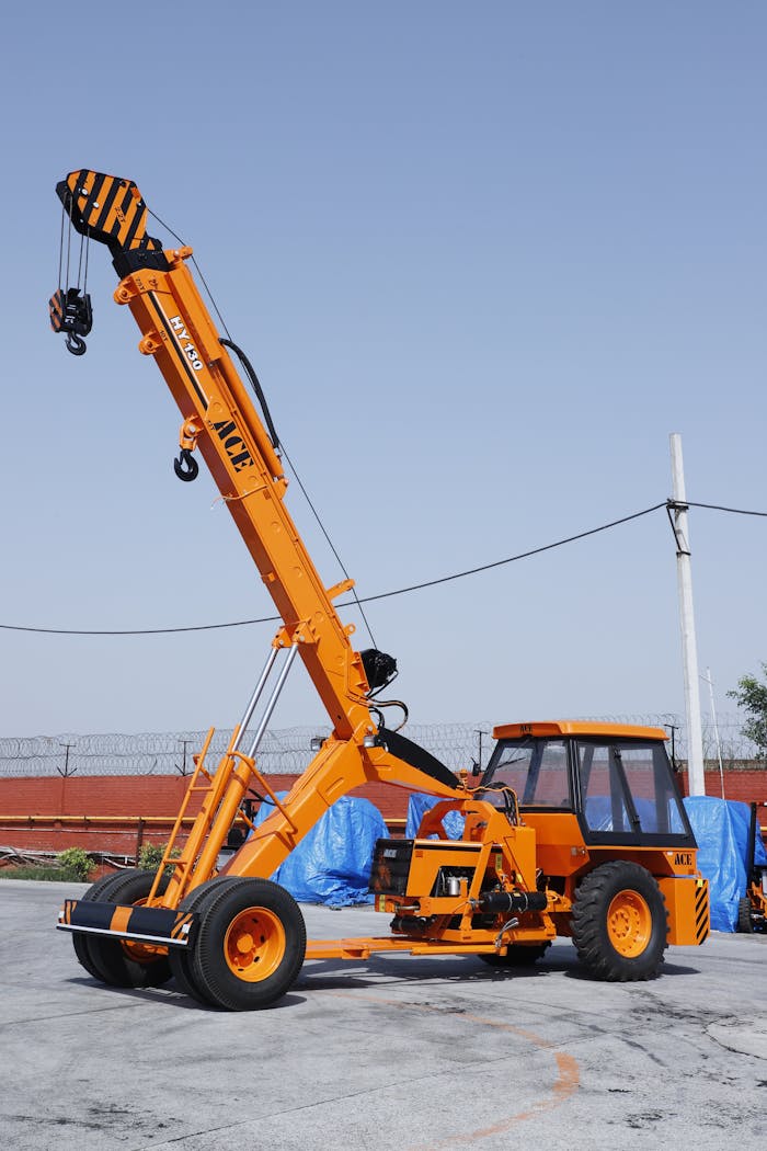 portfolio-03 ACE HY130 crane parked outdoors in an industrial setting in Faridabad, India.